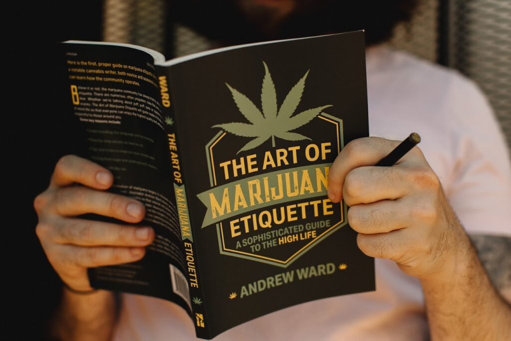 Author Andrew Ward holds up his own book, The Art of Marijuana Etiquette, as a sign of his ability to craft quality written content, cannabis websites and much more