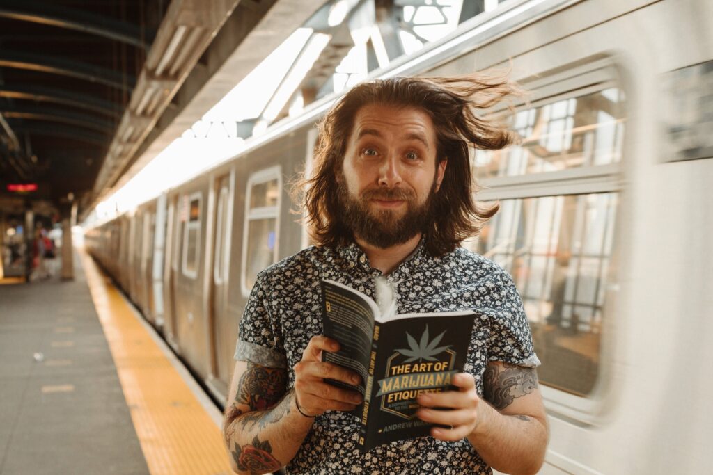 AWARD Creative Content founder and operator Andrew Ward holding his book The Art of Marijuana Etiquette