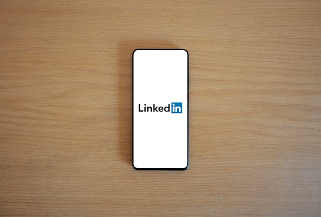 A smartphone screen displaying the LinkedIn logo, reflecting mobile-friendly access to a professional networking platform.